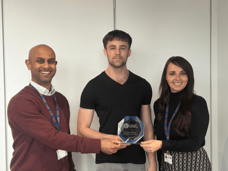 Dom Carpenter is presented with his award for the Velocity Apprentice of the Month for January by Frank Manoharan, Corporate Head of ICT & Digital, and Julie Thompson, IT Service Delivery Manager